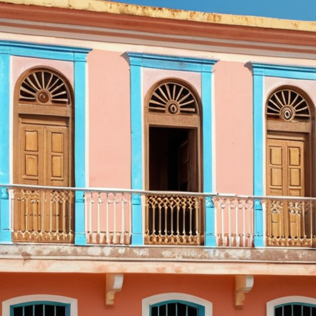A pastel-colored colonial building in the old city of Bissau, Guinea-Bissau, showcasing Portuguese architectural influence with delicate decorations and sunlit facade.